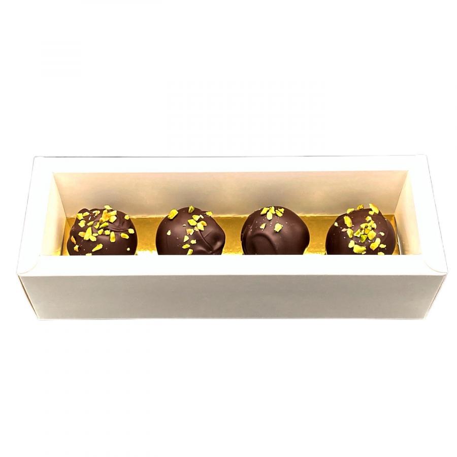 4 extra große Mozartkugeln von Pralinenart in einer weißen Schachtel auf goldenem Boden